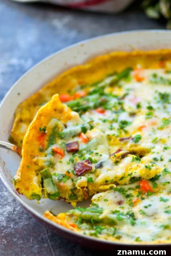 Swiss Cheese, Asparagus, and Bacon Frittata 6 A chef's hand sprinkling shredded Swiss cheese over the partially cooked frittata in the skillet, ready for broiling.