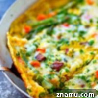 Swiss Cheese, Asparagus, and Bacon Frittata 8 Swiss Cheese Asparagus Bacon Frittata with a golden crust and fresh herbs.
