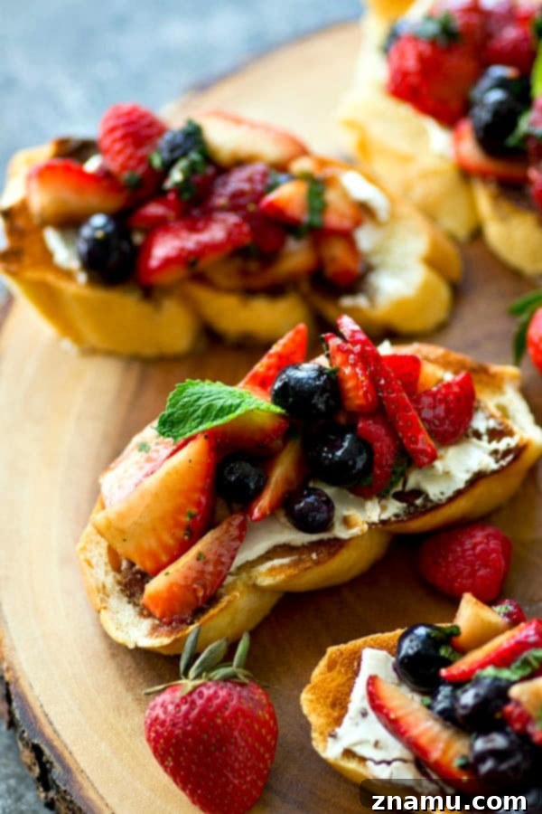 Sunrise Berry Cream Cheese Bruschetta 4 A tray of freshly prepared mixed berry cream cheese breakfast bruschetta, ready to be served for a festive brunch. The berries are artfully arranged.