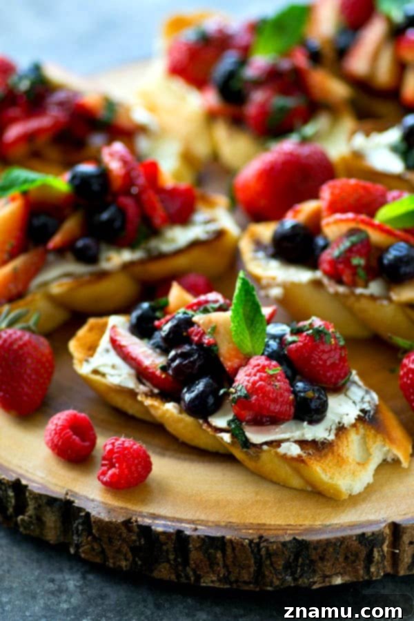 Sunrise Berry Cream Cheese Bruschetta 6 A tantalizing overhead shot of the mixed berry cream cheese breakfast bruschetta, showcasing the bounty of fresh berries on each toast slice.