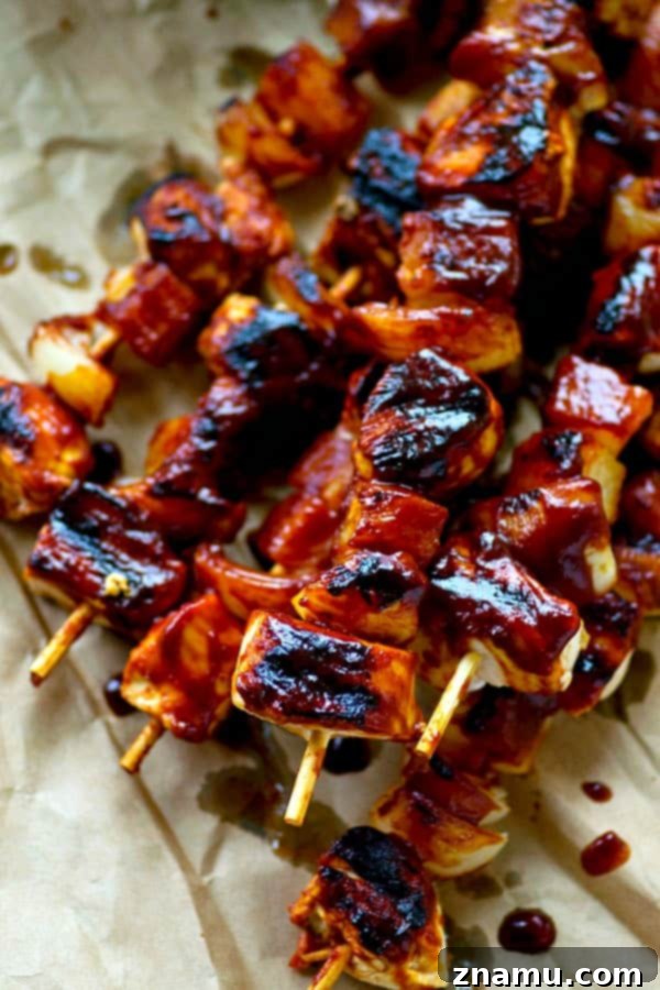 Aloha Chicken Kebabs 5 Plated Hawaiian BBQ Chicken Kebabs served with extra sauce for dipping.