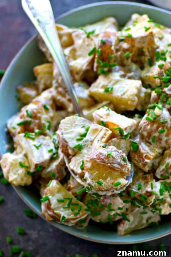 Elevated Roasted Potato Salad with Zesty Chive Ranch 4 Close-up of the creamy texture of the roasted potato salad with chive ranch dressing, showcasing its delectable appeal.