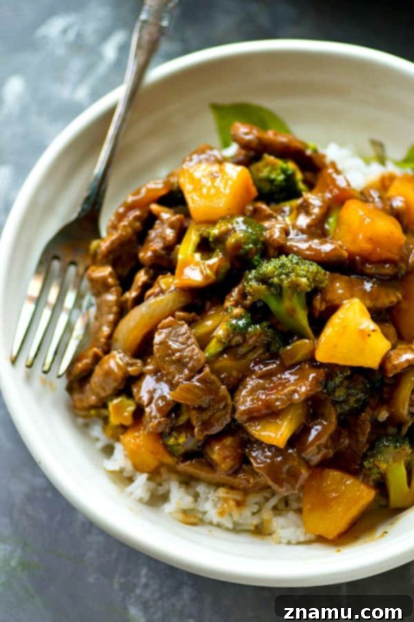 Golden Pineapple Beef and Broccoli Wok 2 Delicious Pineapple Beef and Broccoli Stir-Fry served over a bed of fluffy rice