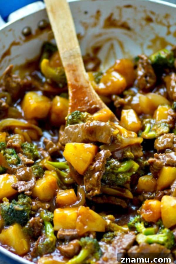 Golden Pineapple Beef and Broccoli Wok 4 A skillet full of cooked Pineapple Beef and Broccoli Stir-Fry ready to be served