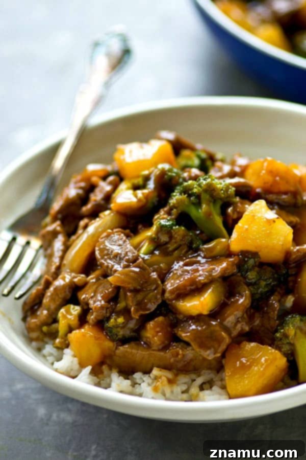 Golden Pineapple Beef and Broccoli Wok 6 Cooked Pineapple Beef and Broccoli Stir-Fry with visible sauce and glaze