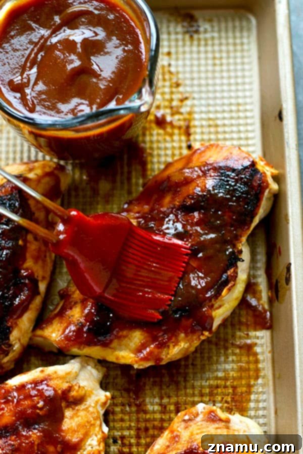 Sun-Kissed Mango BBQ Chicken 3 A close-up of grilled chicken on a plate, glistening with sweet mango barbecue sauce