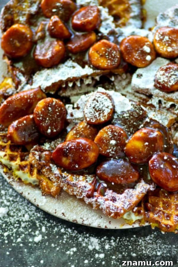 Crispy Waffled French Toast with Mocha Caramelized Bananas 3 A closer view of the beautifully textured waffled French toast, topped with luscious mocha caramelized banana sauce and a light dusting of powdered sugar, showcasing the rich colors and inviting details of this gourmet breakfast dish.