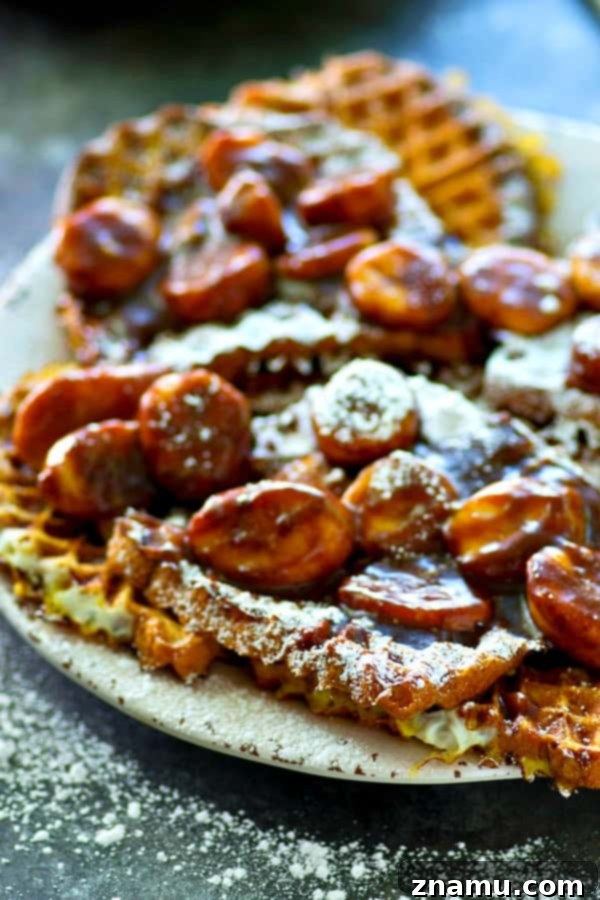 Crispy Waffled French Toast with Mocha Caramelized Bananas 4 Three slices of waffled French toast, cooked to golden perfection and ready for topping, highlighting the distinctive waffle pattern created by the waffle iron, on a white plate.