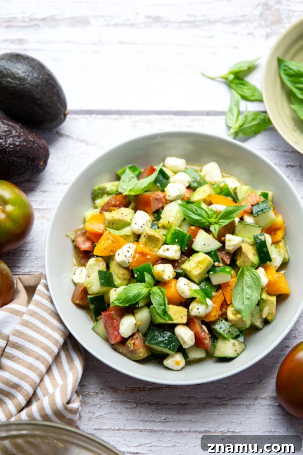Classic Italian Tomato Cucumber Salad 4 A serving of the Italian Tomato Cucumber Salad, showing the beautiful presentation of the ingredients in a bowl, ready to be enjoyed.