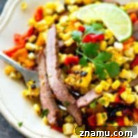 Juicy grilled skirt steak is piled high with a flavorful charred corn sweet pepper salsa and is hands down the BEST summer steak dinner you'll ever have!