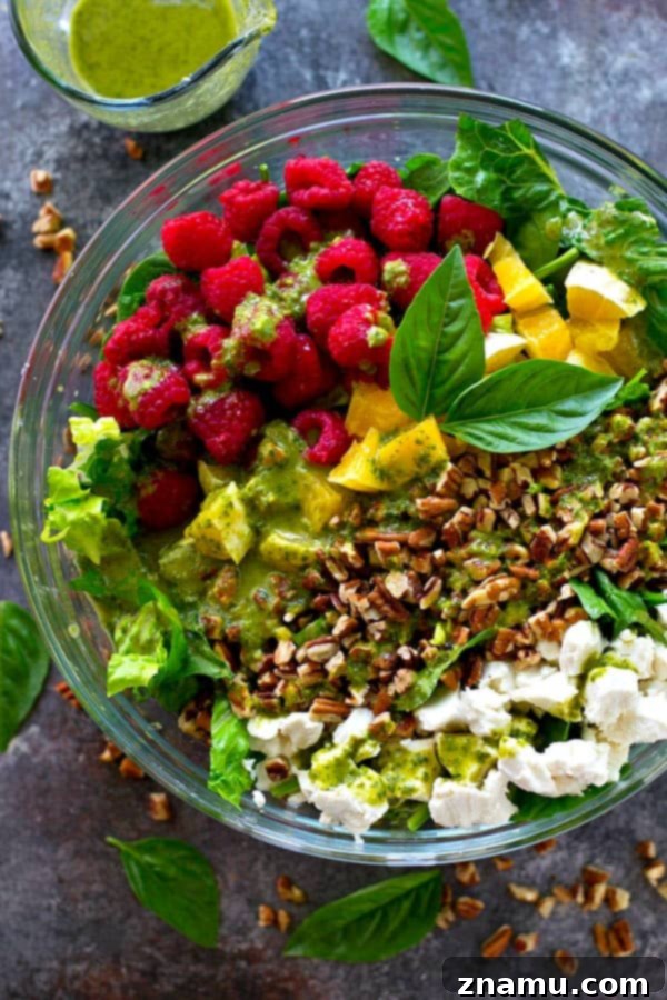 A single serving of the refreshing Raspberry Pecan Goat Cheese Salad, ready to be enjoyed as a light meal.