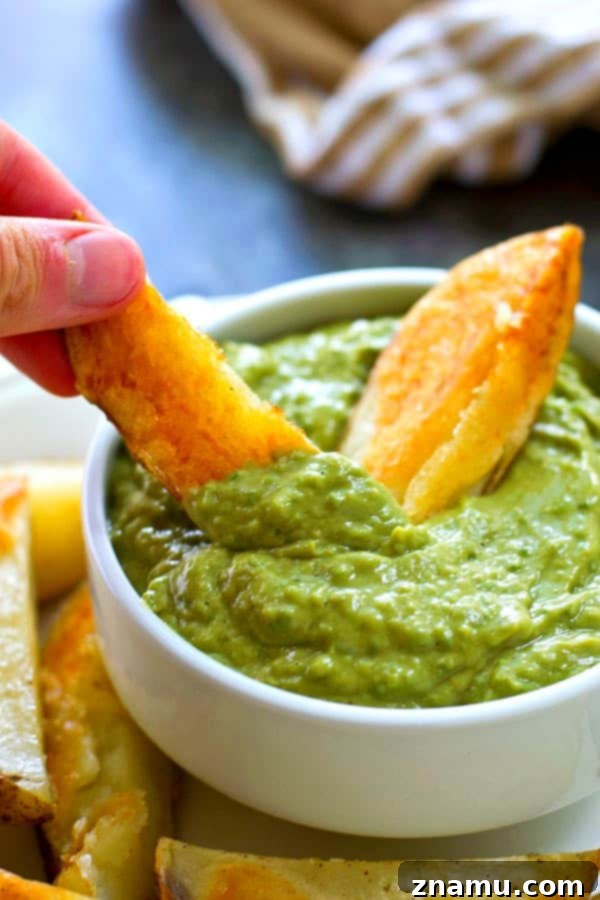 Golden Crispy Wedges with Creamy Poblano Avocado Ranch 4 A serving of crispy potato wedges arranged beautifully with a bowl of green poblano avocado ranch dip