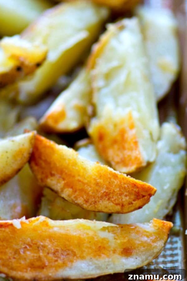Golden Crispy Wedges with Creamy Poblano Avocado Ranch 5 A baking sheet filled with golden, crispy baked potato wedges, fresh out of the oven