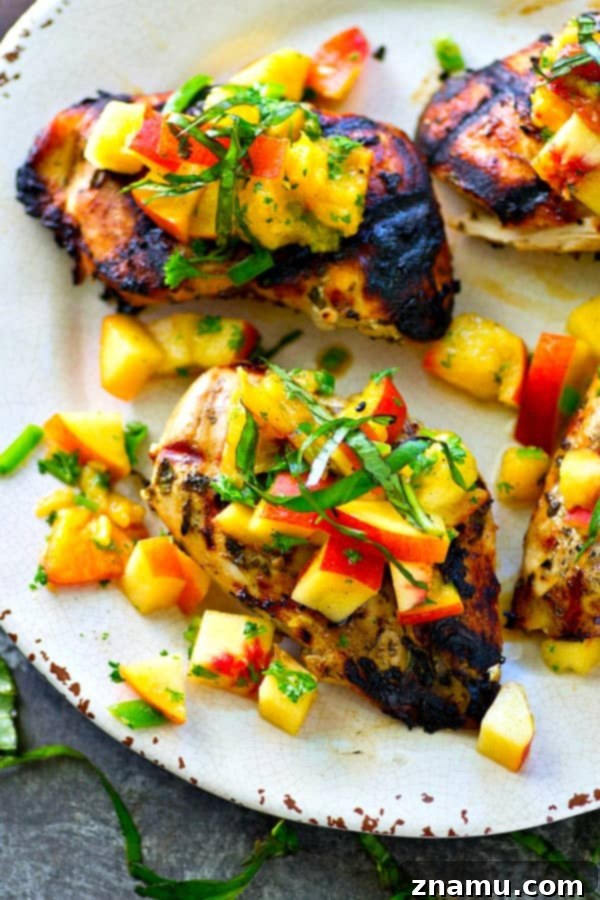 This juicy grilled chicken is marinated in the most flavorful basil sauce and a fresh peach salsa piled on top brings out all the best summer flavors! --- Let the chicken slowly marinate overnight for the best results.
