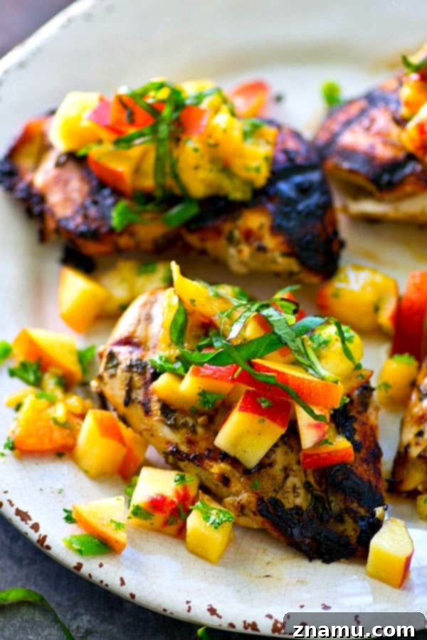 This juicy grilled chicken is marinated in the most flavorful basil sauce and a fresh peach salsa piled on top brings out all the best summer flavors! --- Let the chicken slowly marinate overnight for the best results.