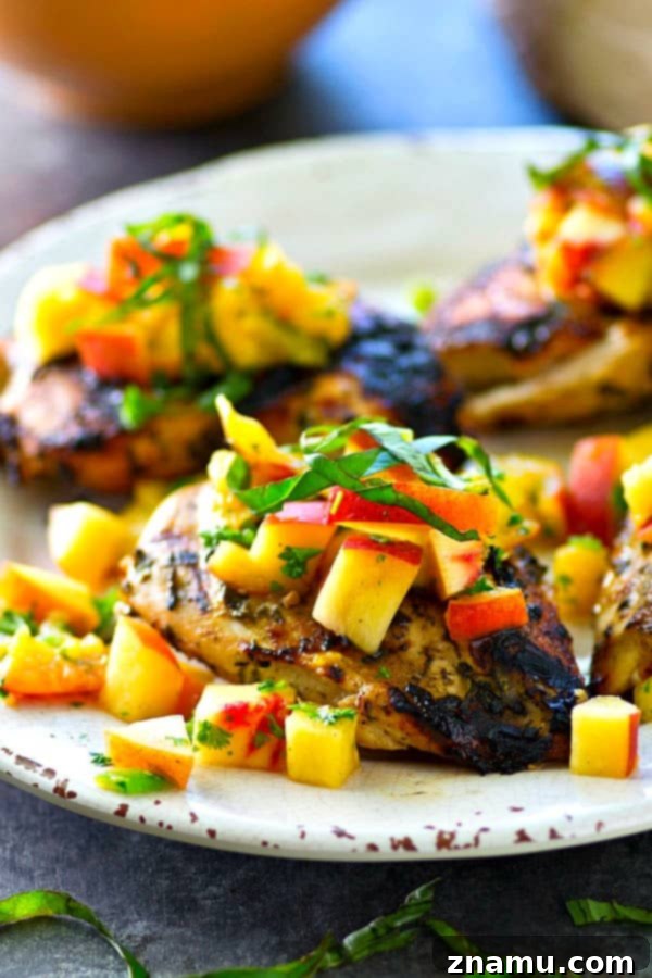 This juicy grilled chicken is marinated in the most flavorful basil sauce and a fresh peach salsa piled on top brings out all the best summer flavors! --- Let the chicken slowly marinate overnight for the best results.