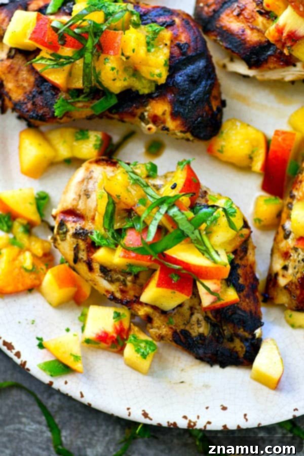 This juicy grilled chicken is marinated in the most flavorful basil sauce and a fresh peach salsa piled on top brings out all the best summer flavors! --- Let the chicken slowly marinate overnight for the best results.