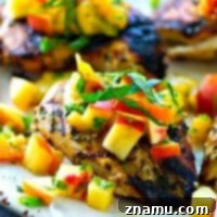 This juicy grilled chicken is marinated in the most flavorful basil sauce and a fresh peach salsa piled on top brings out all the best summer flavors! --- Let the chicken slowly marinate overnight for the best results.