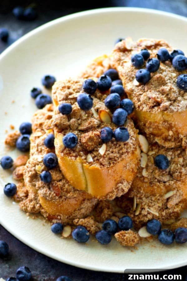 Decadent Baked Almond Streusel French Toast 4 Several slices of baked almond streusel French toast arranged beautifully, highlighting the golden crust.