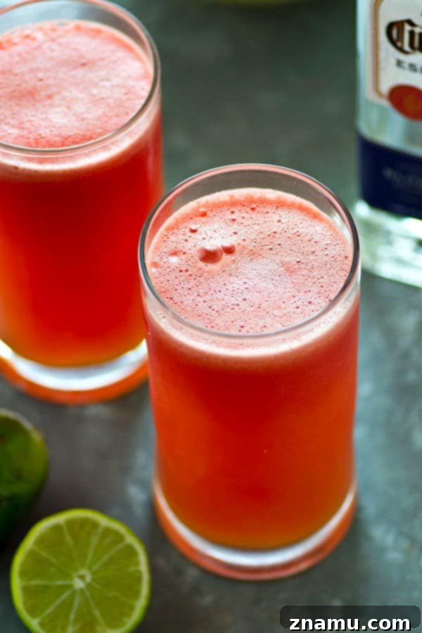 Bubbly Watermelon Lime Margarita Slush 4 Three perfectly blended Sparkling Watermelon Lime Margarita Slushies arranged enticingly, ready to be enjoyed at any summer party.