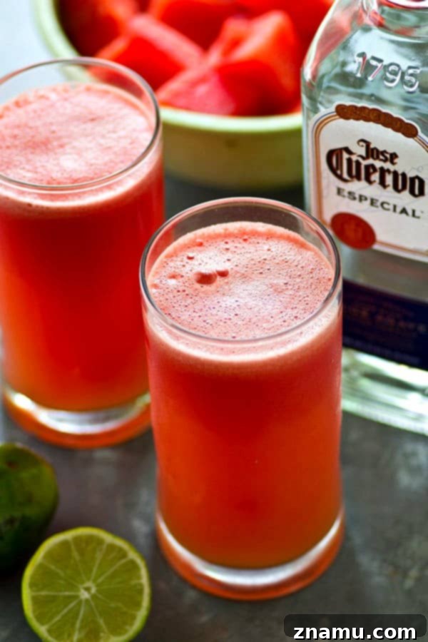 Bubbly Watermelon Lime Margarita Slush 5 A refreshing Sparkling Watermelon Lime Margarita Slushie in hand, complemented by fresh lime slices, symbolizing cool relief and vibrant taste.