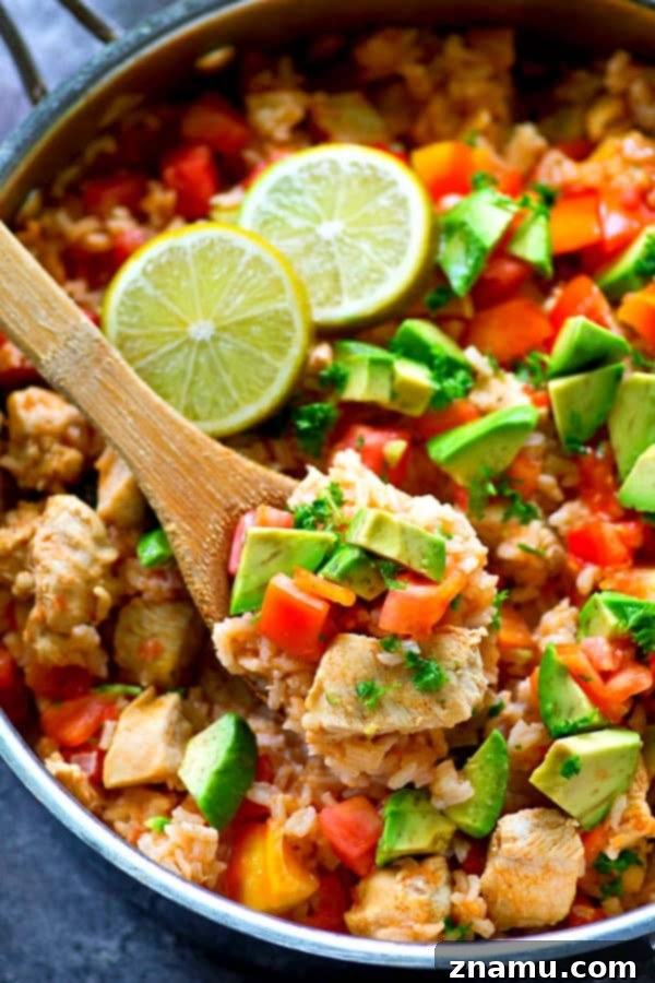 Fiesta Chicken and Rice Skillet 3 A close-up of the delectable Mexican chicken and rice skillet, showcasing the perfectly cooked chicken, rice, and colorful vegetables.