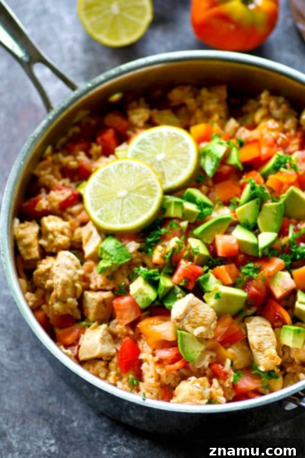 Fiesta Chicken and Rice Skillet 4 The initial ingredients, including chicken, peppers, onions, and garlic, being sautéed in a single large skillet.