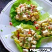 The EASIEST lettuce wraps you will ever make! These tropical-style pineapple pecan chicken salad lettuce wraps are a lunchtime game-changer.
