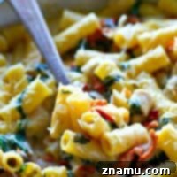 Tuscan Chicken Alfredo with Sun-Dried Tomatoes and Spinach 7 A beautifully presented One-Pot Sun-Dried Tomato Spinach Chicken Pasta Alfredo, highlighting creamy sauce, tender chicken, fresh spinach, and vibrant sun-dried tomatoes.