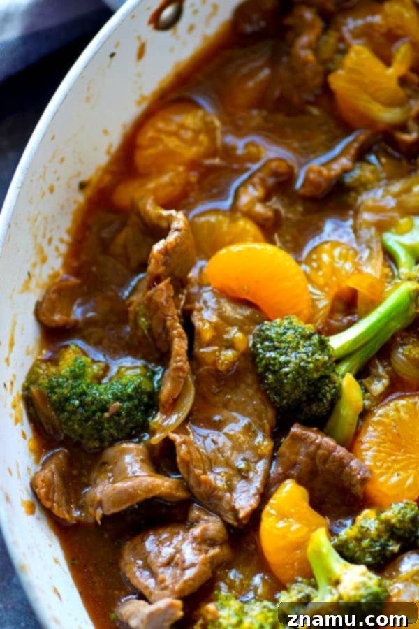 Zesty Orange Teriyaki Beef and Broccoli Stir Fry 3 Close-up of beef and broccoli stir-fry with vibrant orange teriyaki sauce