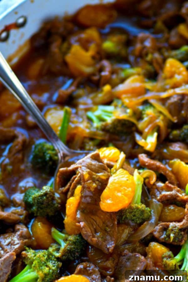 Zesty Orange Teriyaki Beef and Broccoli Stir Fry 4 Fresh broccoli florets and thinly sliced beef cooking in a pan for stir-fry