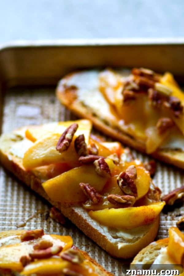 Caramel Apple Cream Cheese Crostini 5 Close-up of a single slice of Caramelized Apple Cream Cheese Bruschetta, showing off the generous topping and golden toast.
