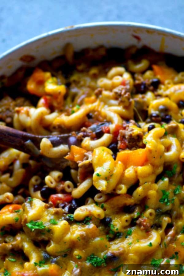 Lean Skillet Beef Chili Mac n Cheese 3 Close-up of One-Pot Beef Chili Mac and Cheese, showcasing the rich texture of ground beef, beans, and tender elbow pasta in a savory sauce.