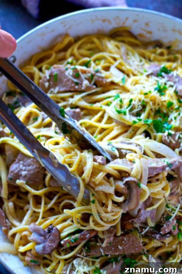Balsamic Glazed Beef & Wild Mushroom Alfredo 4 Fresh ingredients for Mushroom Balsamic Beef Fettuccine Alfredo on a cutting board, including mushrooms, onion, and beef.