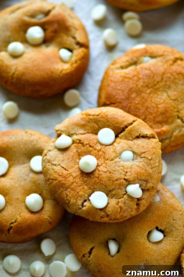 Chewy Coconut White Chocolate Molasses Delights 4 Golden brown white chocolate molasses cookies cooling on a wire rack.
