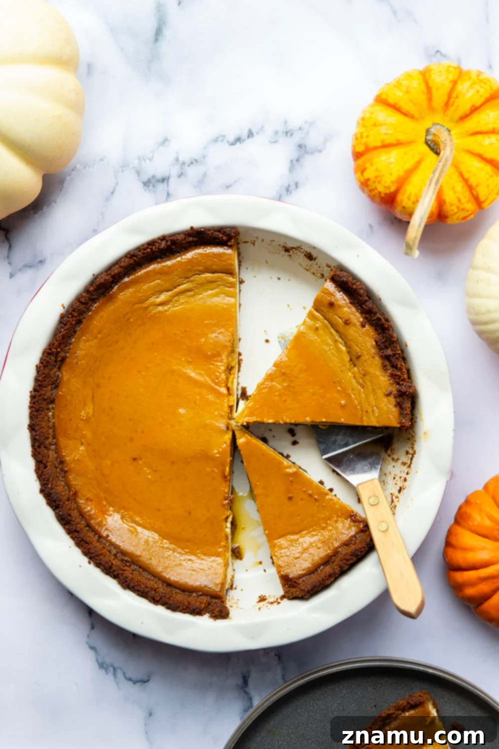 Harvest Pumpkin Cheesecake Delight 4 A whole pumpkin cheesecake pie cooling on a wire rack.