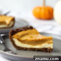 A slice of Gingersnap Pumpkin Cheesecake Pie.