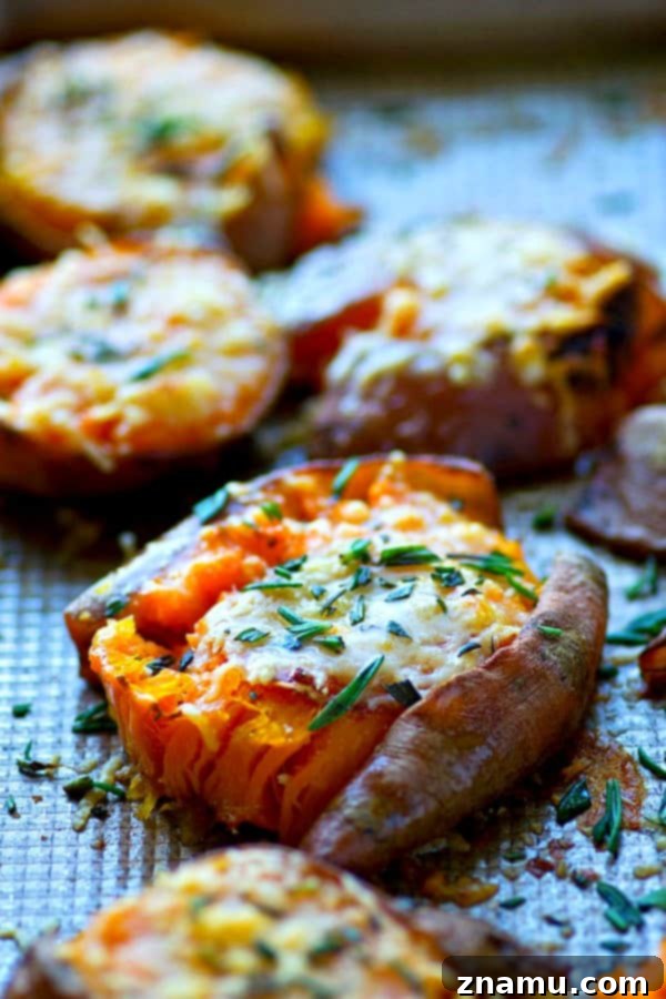 Brown Butter Parmesan Sweet Potato Smash 2 Crispy Smashed Sweet Potatoes with Browned Butter and Parmesan on a baking sheet