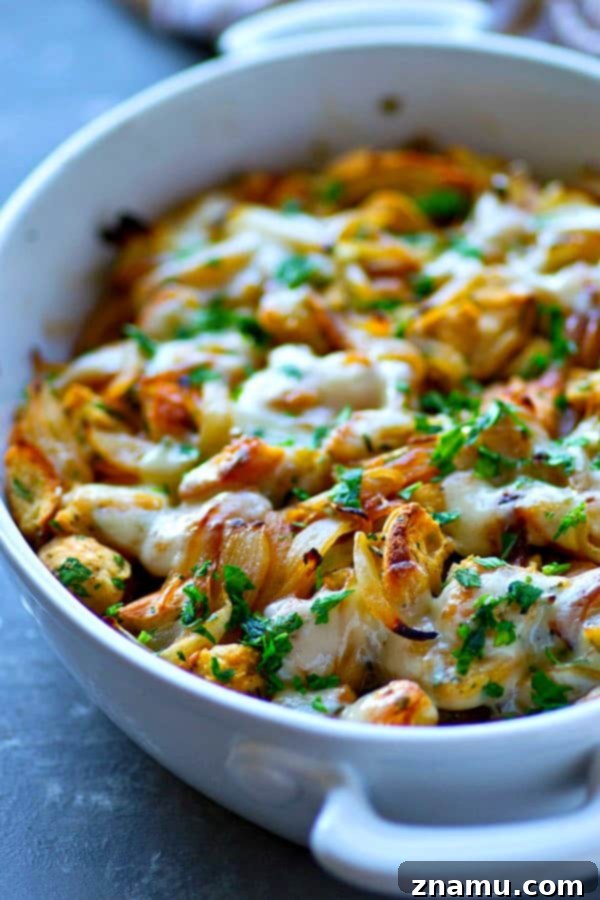 Ultimate Caramelized French Onion Soup Stuffing 5 Close-up of golden, bubbly Swiss cheese melted over French Onion Soup Stuffing