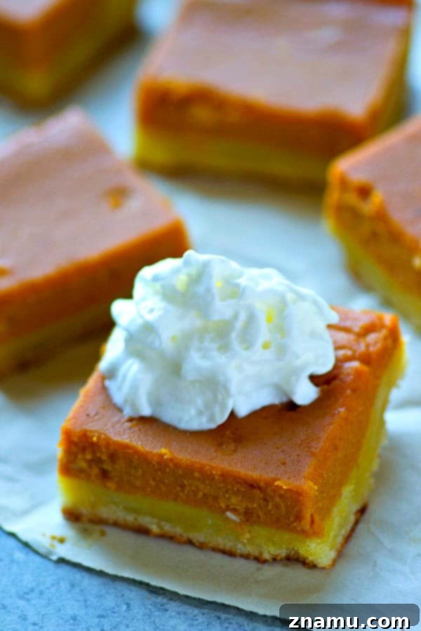 Spiced Bourbon Pumpkin Cookie Bars 3 Close-up of a stack of Sugar Cookie Bourbon Pumpkin Pie Bars, showcasing the thick cookie crust and creamy pumpkin filling.