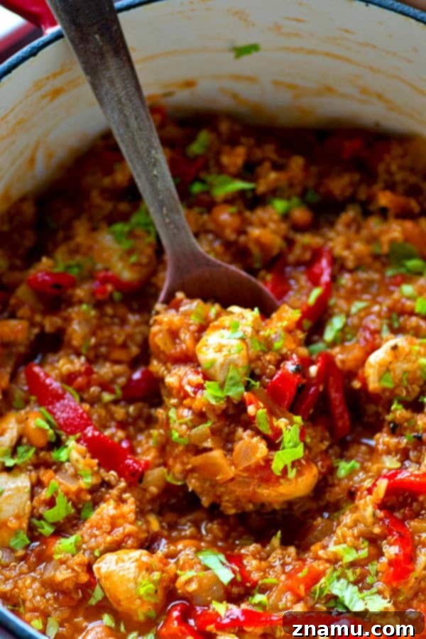 Close-up of a bowl of Roasted Red Pepper Quinoa Turkey Chili, showcasing its rich texture and vibrant color.
