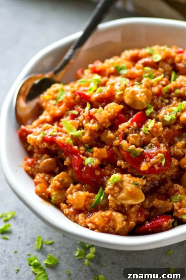 A hearty pot of Roasted Red Pepper Quinoa Turkey Chili simmering on the stove.
