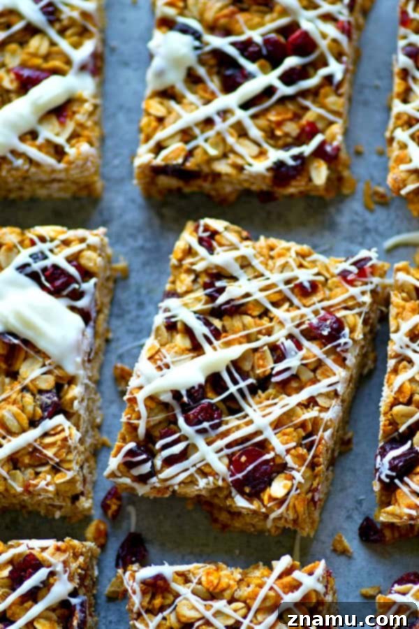 Heavenly White Chocolate Cranberry Granola Bars 2 Delicious White Chocolate Cranberry Bliss Granola Bars, a perfect blend of tangy cranberries and sweet white chocolate, arranged neatly on a serving platter.