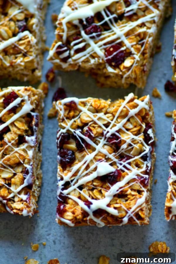 Heavenly White Chocolate Cranberry Granola Bars 5 A tray of golden-brown White Chocolate Cranberry Bliss Granola Bars, ready for the final step of white chocolate drizzling, hinting at the perfect chewy texture.