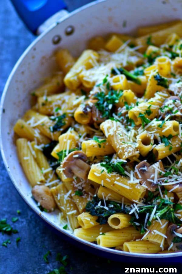Browned Butter Rigatoni with Caramelized Mushrooms and Kale 2 A vibrant close-up of browned butter rigatoni with caramelized mushrooms and kale in a skillet, showcasing the rich colors and textures.