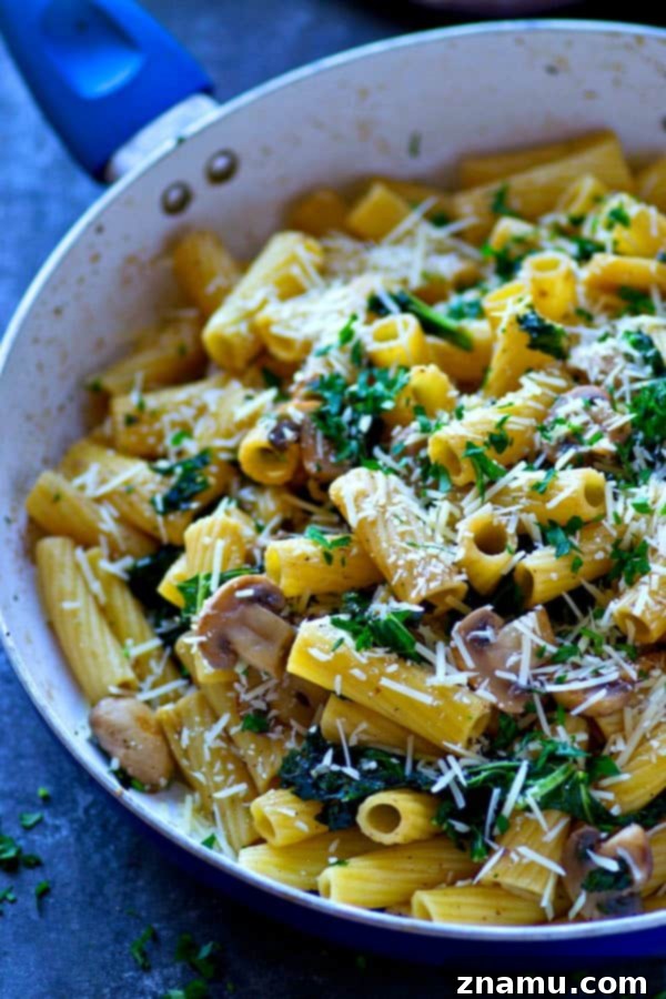Browned Butter Rigatoni with Caramelized Mushrooms and Kale 5 Close-up of rigatoni pasta coated in rich browned butter sauce with tender mushrooms and kale, showcasing the texture of the sauce and pasta.