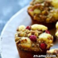 Deliciously moist Cranberry Lemon Walnut Crumb Muffins with a generous streusel topping, perfect for holiday gatherings.