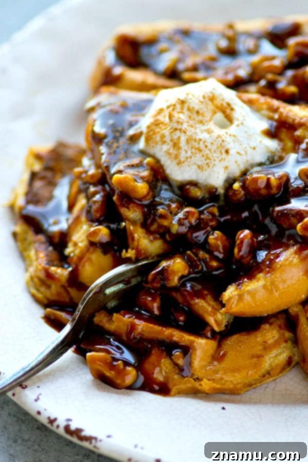 Spiced Gingerbread French Toast with Toasted Walnut Caramel Drizzle 5 Plate of perfectly golden Gingerbread French Toast slices, swimming in a generous pool of homemade Walnut Caramel Sauce, highlighting its decadent appeal.