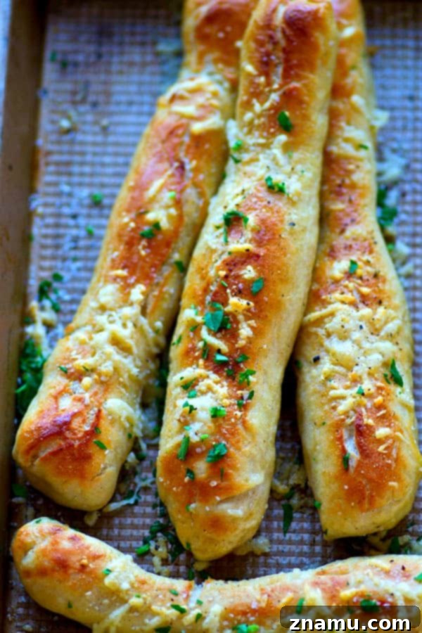 Serving of Soft Pretzel Breadsticks with various dips, showcasing their perfect texture