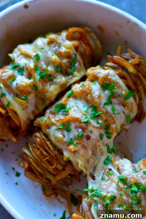 Loaded French Onion Hasselback Potatoes 3 Close-up of Hasselback Baked Potato bursting with caramelized onions and melted Swiss cheese
